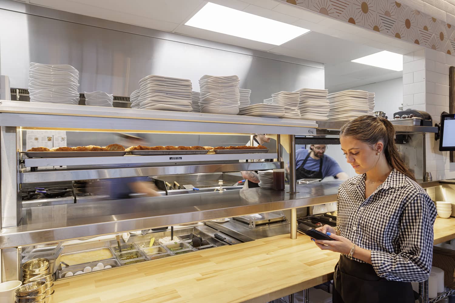 server putting in an order at the kitchen at the Buttered Biscuit