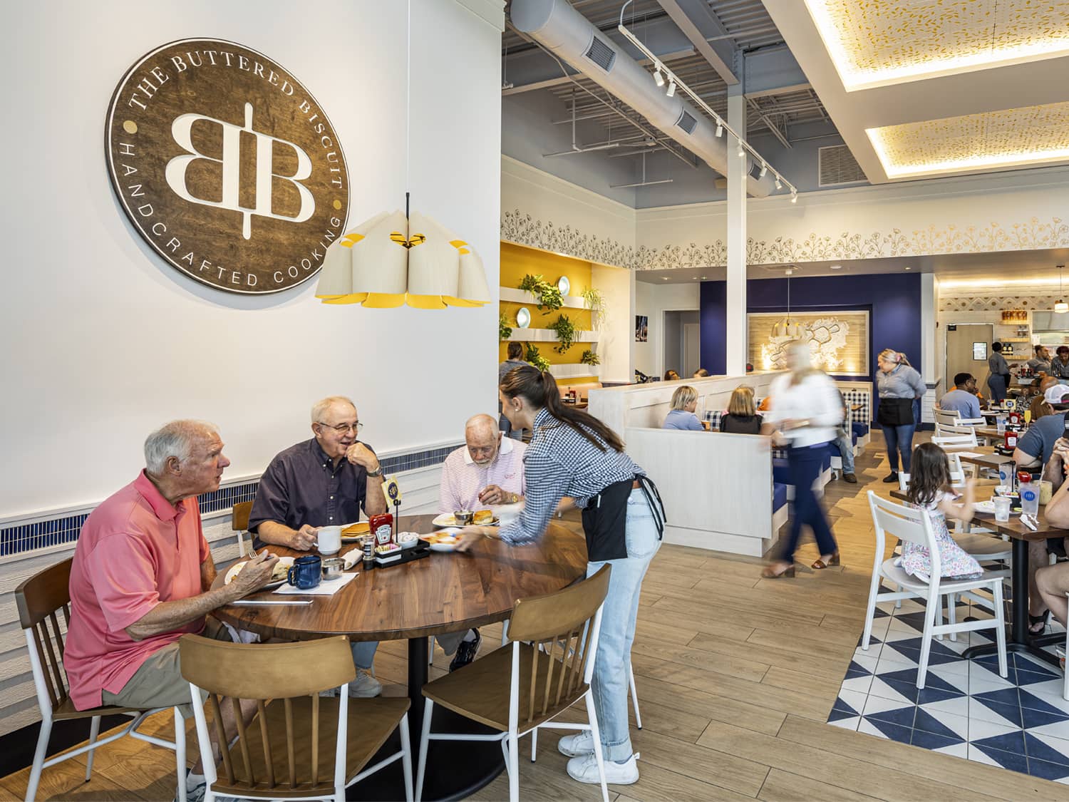server giving patrons their food at the Buttered Biscuit