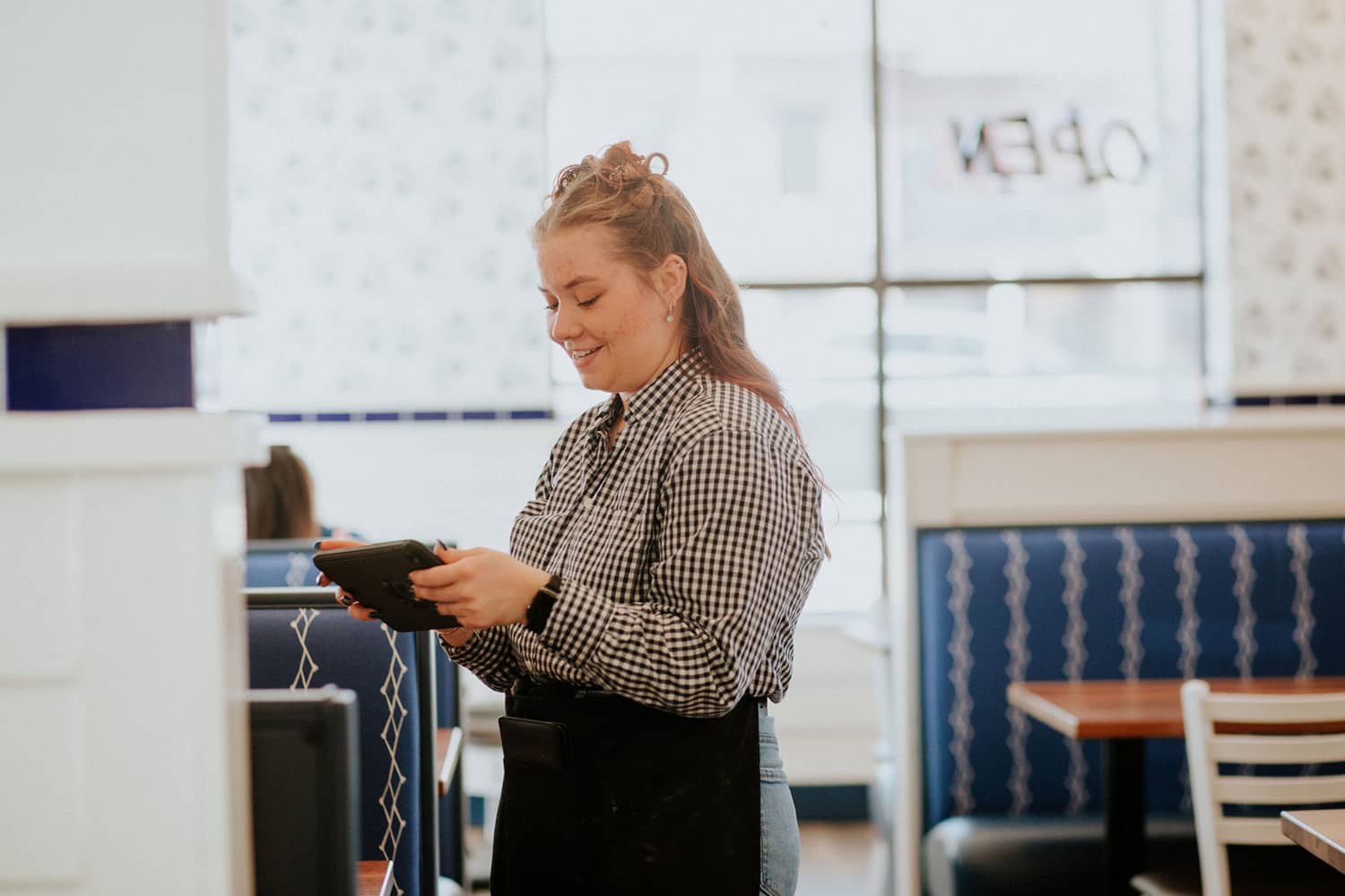 waitress at the Buttered Biscuit taking orders