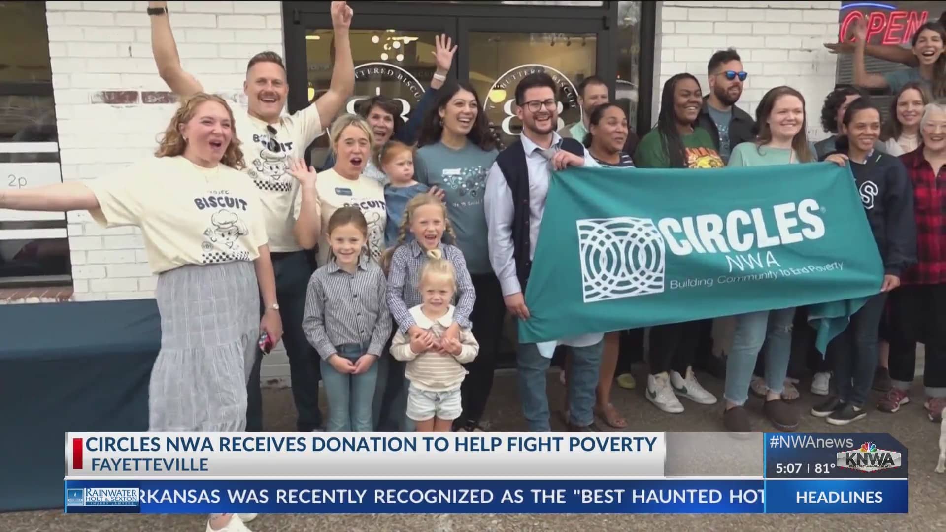 crowd of people behind a sign saying