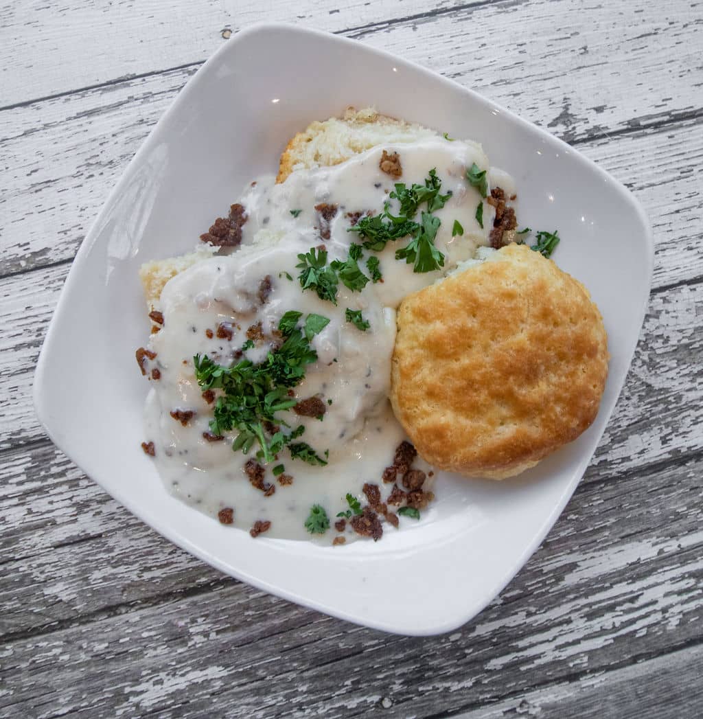 biscuit and gravy in a white bowl