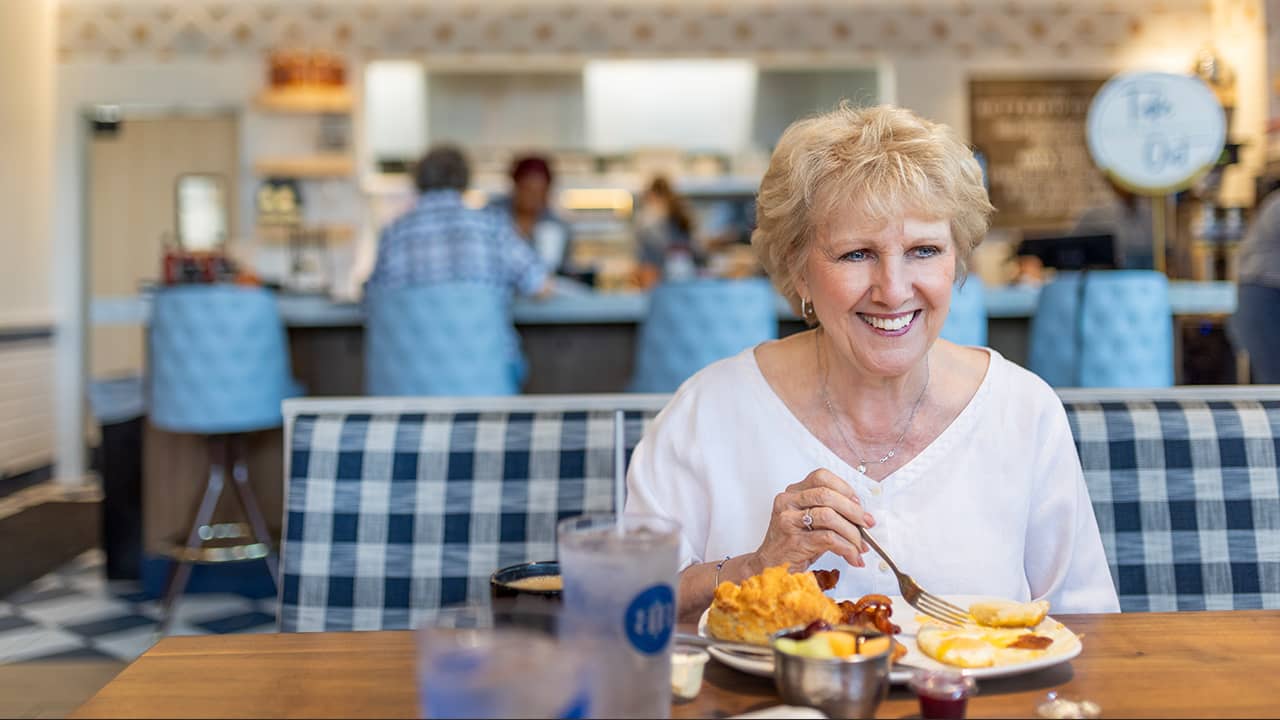 woman eating breakfast at the buttered biscuit restaurant