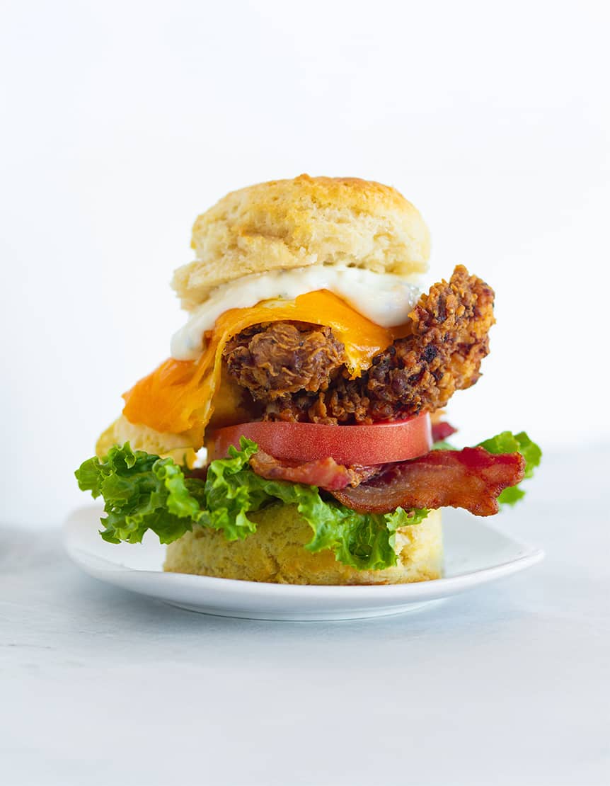 eureka sandwich with chicken, bacon, lettuce, tomato and cheddar on a biscuit