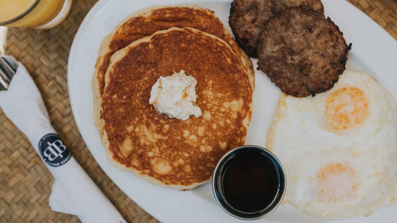 breakfast with pancakes, sausage and eggs