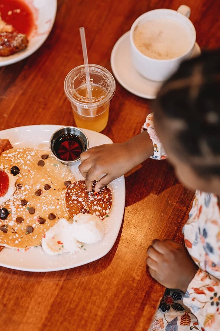 overhead view of a child eating mini me pancakes