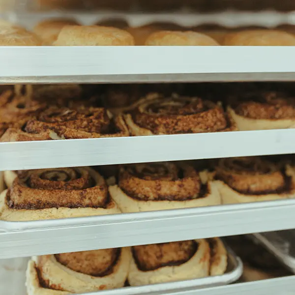 cinnamon rolls on trays