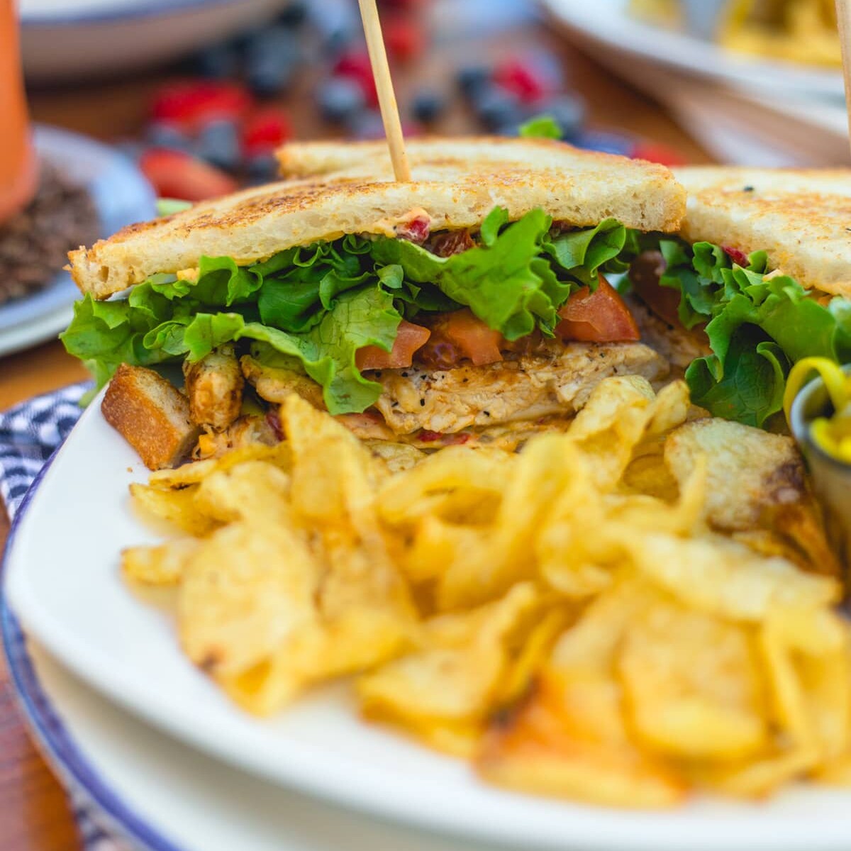 A delicious sandwich and chips, served for lunch.