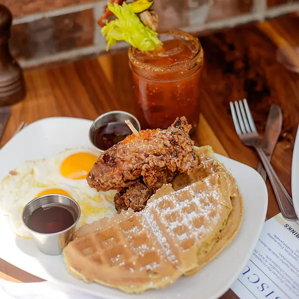 fried chicken and waffles with a bloody mary